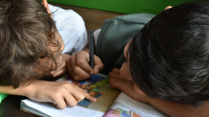boy's writing on book
